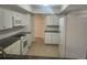 Clean, white kitchen with stainless steel appliances and dark granite countertops at 9179 Gillmar St, Spring Hill, FL 34608