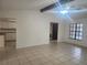 A bright living room with tile floors and a window, adjacent to the kitchen at 9179 Gillmar St, Spring Hill, FL 34608