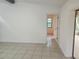 Open living room with neutral tile flooring and natural light from the doorway at 9179 Gillmar St, Spring Hill, FL 34608