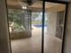 Sliding glass doors that lead to a serene pool area from the home's interior at 9179 Gillmar St, Spring Hill, FL 34608