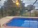 Screened-in pool with a view of the green backyard through the mesh at 9179 Gillmar St, Spring Hill, FL 34608