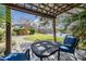 Backyard patio with outdoor seating underneath a trellis with a waterfront view at 12824 Tikal Way, Trinity, FL 34655