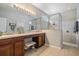The bathroom features a double sink vanity and a large glass walk-in shower at 12824 Tikal Way, Trinity, FL 34655