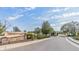 Inviting entrance to Trinity East with stone signage, landscaping, and a gated entry at 12824 Tikal Way, Trinity, FL 34655