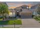 Beautiful single-Gathering home featuring a well-manicured lawn, two-car garage, and a cozy front porch at 12824 Tikal Way, Trinity, FL 34655