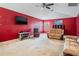 This spacious living room features plush carpet, a ceiling fan, and large windows at 12824 Tikal Way, Trinity, FL 34655