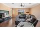 Comfortable living room with a large leather couch, entertainment center, and a ceiling fan at 12824 Tikal Way, Trinity, FL 34655