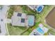 Overhead view showcasing a backyard with a pool, patio, and lush landscaping at 1337 Halapa Way, Trinity, FL 34655