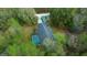 An aerial view shows this home's backyard pool, acreage, and two storage buildings at 16325 Hibiscus Rd, Brooksville, FL 34601