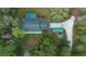Drone shot of house with pool, long driveway, and storage sheds at 16325 Hibiscus Rd, Brooksville, FL 34601