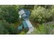 Aerial view of a wooded property featuring lush landscaping and a private drive at 16325 Hibiscus Rd, Brooksville, FL 34601