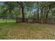 A bench sits behind a fence in the backyard. A metal gate offers backyard access at 16325 Hibiscus Rd, Brooksville, FL 34601