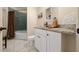 Bright bathroom featuring granite counters, white cabinets, and a tub with tiled shower at 16325 Hibiscus Rd, Brooksville, FL 34601