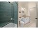 Bathroom showcasing a shower and tub combination with green tile and modern fixtures at 16325 Hibiscus Rd, Brooksville, FL 34601