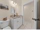 Bathroom showcasing a vanity with granite countertop, white cabinets, and tile flooring at 16325 Hibiscus Rd, Brooksville, FL 34601