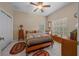 Bedroom featuring a ceiling fan, natural light, and tile flooring at 16325 Hibiscus Rd, Brooksville, FL 34601