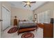 Bedroom featuring a ceiling fan, natural light, and tile flooring at 16325 Hibiscus Rd, Brooksville, FL 34601
