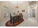 Cozy dining room with decorative chandelier and lots of natural light at 16325 Hibiscus Rd, Brooksville, FL 34601