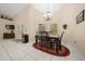 Inviting dining room with vaulted ceilings and decorative lighting fixture at 16325 Hibiscus Rd, Brooksville, FL 34601