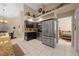 Modern kitchen with stainless steel appliances and sleek dark cabinets adjacent to an open dining area at 16325 Hibiscus Rd, Brooksville, FL 34601