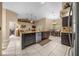 Spacious kitchen island with dark cabinets, a sink, and an open view to living and dining areas at 16325 Hibiscus Rd, Brooksville, FL 34601