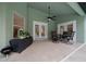 A covered patio with ceiling fan offers outdoor dining and adjoins the screened-in pool at 16325 Hibiscus Rd, Brooksville, FL 34601