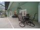 A covered patio with ceiling fan offers outdoor dining beside the screened-in pool at 16325 Hibiscus Rd, Brooksville, FL 34601