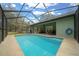 A stunning screened-in pool offers a relaxing retreat in a private backyard setting at 16325 Hibiscus Rd, Brooksville, FL 34601