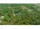 Aerial view displaying the outlined property with the home nestled among dense trees at 16325 Hibiscus Rd, Brooksville, FL 34601