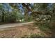 Driveway leading to a beautiful home with well maintained grounds. Mature trees line the long drive at 16325 Hibiscus Rd, Brooksville, FL 34601