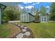 Two storage buildings are nestled in the grassy backyard with a stone pathway at 16325 Hibiscus Rd, Brooksville, FL 34601