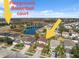 Aerial view of homes near pond featuring playground and basketball court at 18819 Sunterra Dr, Land O Lakes, FL 34638