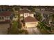 Aerial view of home with a well-manicured lawn, mature trees, and a spacious two-car garage at 18819 Sunterra Dr, Land O Lakes, FL 34638