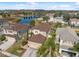 Aerial view of beautiful homes near a pond, showcasing landscaping and backyard features at 18819 Sunterra Dr, Land O Lakes, FL 34638