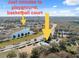 Aerial view of playground and basketball court near a beautiful lake surrounded by greenery at 18819 Sunterra Dr, Land O Lakes, FL 34638