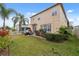 Well-maintained backyard with a patio area, lush lawn, and tropical landscaping, perfect for outdoor entertaining at 18819 Sunterra Dr, Land O Lakes, FL 34638