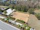 Aerial view showcasing basketball court with hoops, lush green hedges, and paved pathways at 18819 Sunterra Dr, Land O Lakes, FL 34638
