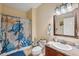 Cozy bathroom with a vanity, shower, and decorative beach-themed accents at 18819 Sunterra Dr, Land O Lakes, FL 34638