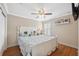 Cozy bedroom features hardwood floors, neutral paint, and a large window at 18819 Sunterra Dr, Land O Lakes, FL 34638