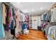 Walk-in closet with custom shelving and hardwood floors offers lots of storage at 18819 Sunterra Dr, Land O Lakes, FL 34638