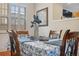 Cozy dining area with wood table, four chairs and window letting in natural light adding warmth to the setting at 18819 Sunterra Dr, Land O Lakes, FL 34638