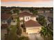 Beautiful two-story home featuring a manicured lawn, brick walkway, and attached two-car garage at 18819 Sunterra Dr, Land O Lakes, FL 34638
