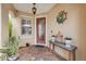 Charming front porch with brick flooring, decorative accents, and a welcoming nautical themed ship wheel art at 18819 Sunterra Dr, Land O Lakes, FL 34638