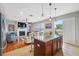 Open-concept kitchen with a central island, granite countertops, and views of the living area at 18819 Sunterra Dr, Land O Lakes, FL 34638