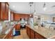 Well-appointed kitchen with granite countertops, stainless steel appliances, and wood cabinetry at 18819 Sunterra Dr, Land O Lakes, FL 34638