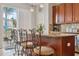 Kitchen breakfast bar featuring granite counters, pendant lighting, and a view to the backyard at 18819 Sunterra Dr, Land O Lakes, FL 34638
