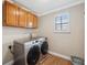 Well-lit laundry room with front load Samsung washer and dryer at 18819 Sunterra Dr, Land O Lakes, FL 34638