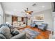 Spacious living room featuring hardwood floors, a ceiling fan, and an open layout to the kitchen at 18819 Sunterra Dr, Land O Lakes, FL 34638