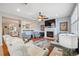 Open-concept living room featuring a fireplace, hardwood floors, modern furniture, and a cozy, inviting atmosphere at 18819 Sunterra Dr, Land O Lakes, FL 34638