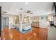 Spacious main bedroom featuring a four-poster bed, hardwood floors, and ample natural light at 18819 Sunterra Dr, Land O Lakes, FL 34638